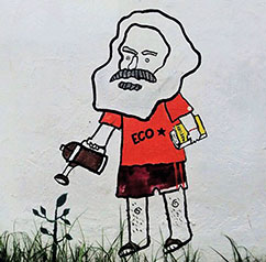 Graffiti auf dem Gelände der Universidad Nacional in Bogotá: Karl Marx gießt das zarte Pflänzchen der gerechten Gesellschaft